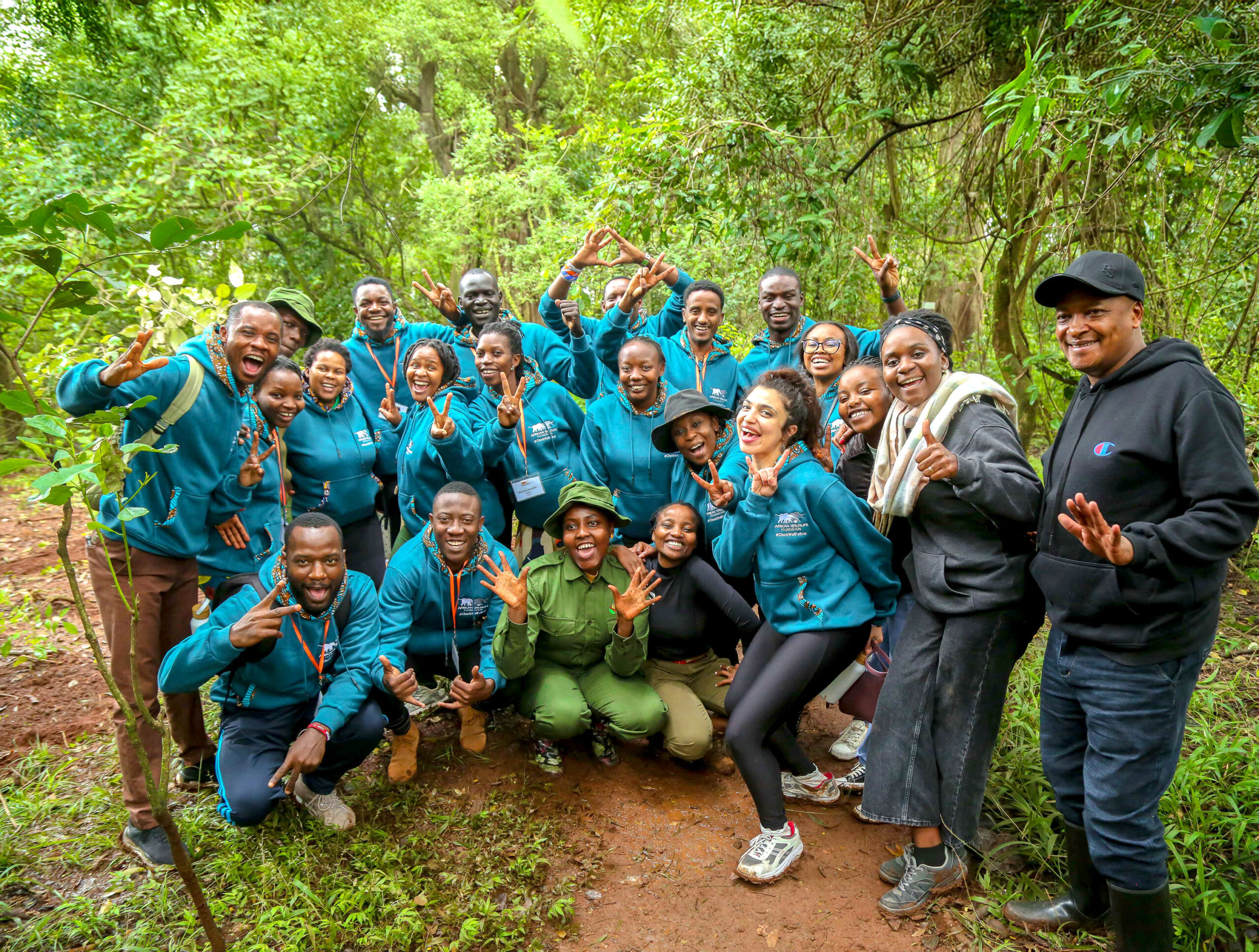 Group photo of fellows in a forest.